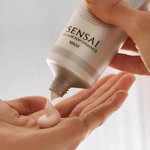 A closeup of Cellular Performance Mask being dispensed onto model's hand from tube